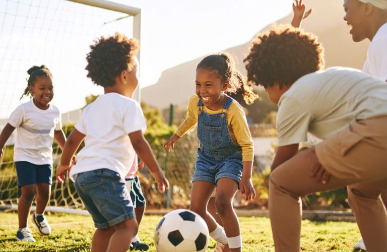 Firefly_A lively outdoor sports complex on a sunny day, featuring young Black children engage 650811